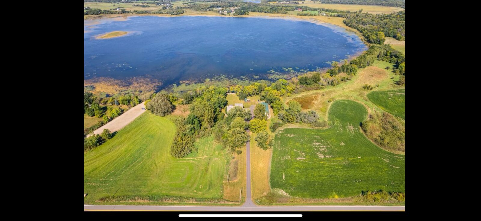 Tree-lined shore and lawn along the water
